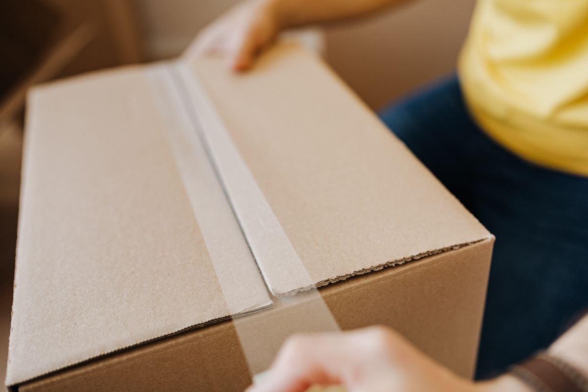 Sealing a cardboard box with packing tape